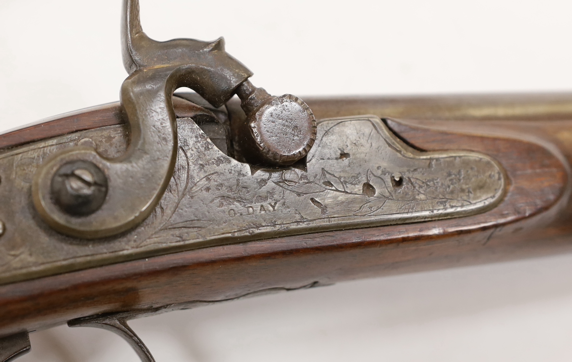 A pair of 12 bore percussion pistols converted from percussion sporting guns, round twist barrels, locks stamped G. Day, iron mounts with nickel fore-end caps and chequered grips